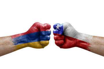 Two hands punch to each others on white background. Country flags painted fists, conflict crisis concept between armenia and chile