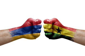 Two hands punch to each others on white background. Country flags painted fists, conflict crisis concept between armenia and ghana