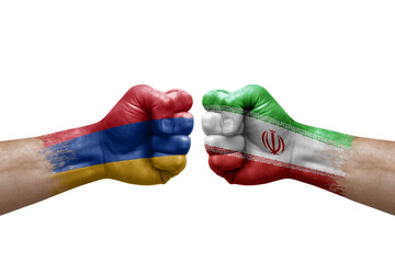 Two hands punch to each others on white background. Country flags painted fists, conflict crisis concept between armenia and iran