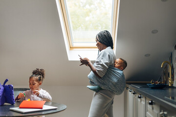 Woman with Her Children Using Mobile Phone