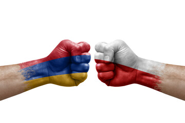 Two hands punch to each others on white background. Country flags painted fists, conflict crisis concept between armenia and poland