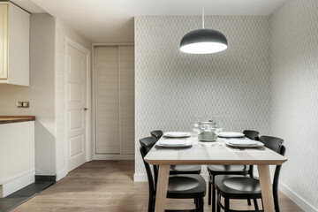 Dining table with black chairs in a modern kitchen office