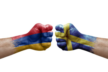 Two hands punch to each others on white background. Country flags painted fists, conflict crisis concept between armenia and sweden