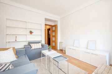 Living room decorated in neutral tones and light wood flooring