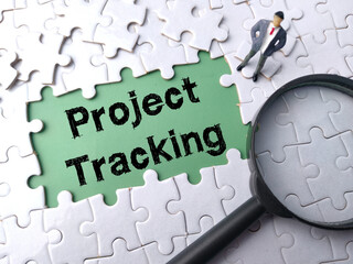 Top view magnifying glass and miniature people with text Project Tracking on a white puzzle background