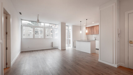 Spacious living room with large windows and contemporary open plan kitchen with generously proportioned island