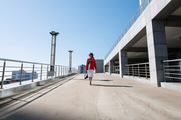 Businesswoman walking outside modern building
