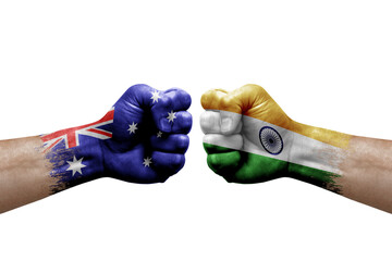 Two hands punch to each others on white background. Country flags painted fists, conflict crisis concept between australia and india