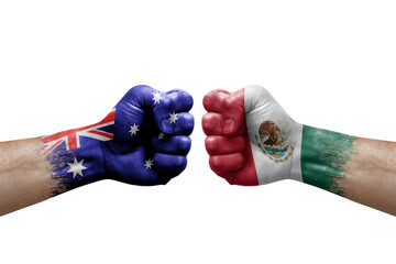 Two hands punch to each others on white background. Country flags painted fists, conflict crisis concept between australia and mexico