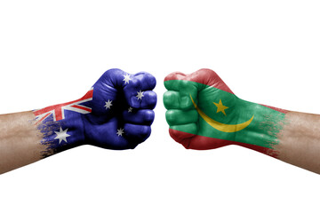 Two hands punch to each others on white background. Country flags painted fists, conflict crisis concept between australia and mauritania