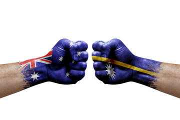 Two hands punch to each others on white background. Country flags painted fists, conflict crisis concept between australia and nauru