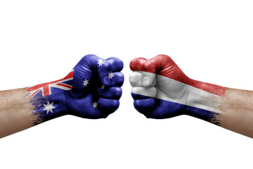 Two hands punch to each others on white background. Country flags painted fists, conflict crisis concept between australia and netherlands