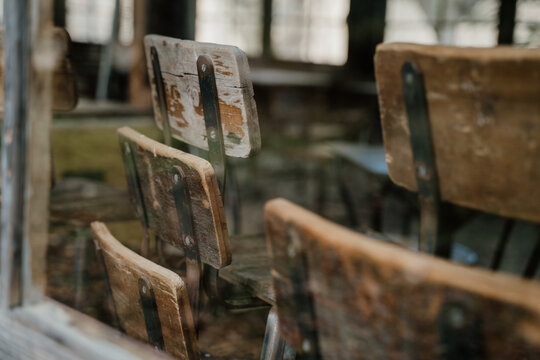 Detail of vintage wooden chairs with chipped paint