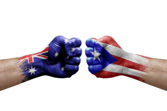 Two hands punch to each others on white background. Country flags painted fists, conflict crisis concept between australia and puerto rico