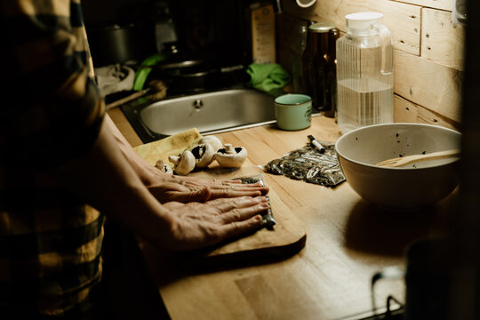 Man batch cooking packing food at home kitchen