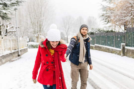 Couple walking around the town under the snow