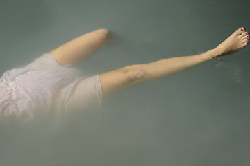 Woman In White Dress Floating On Water 