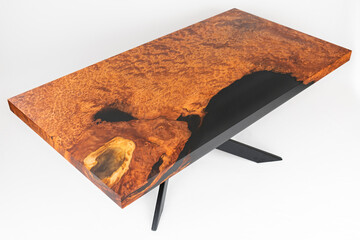 High angle view of wooden table in solid redwood with black epoxy resin and metal legs. White...