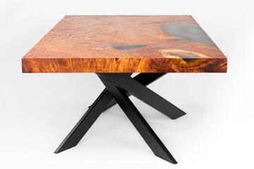 Wooden table in solid redwood with black epoxy resin and metal legs. White studio backdrop. Old growth redwood burl. - obrazy, fototapety, plakaty