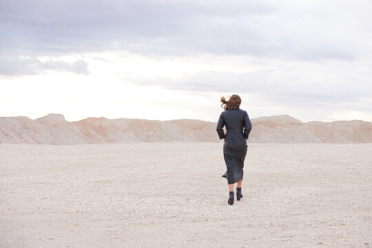 Woman walking at a pink desert area