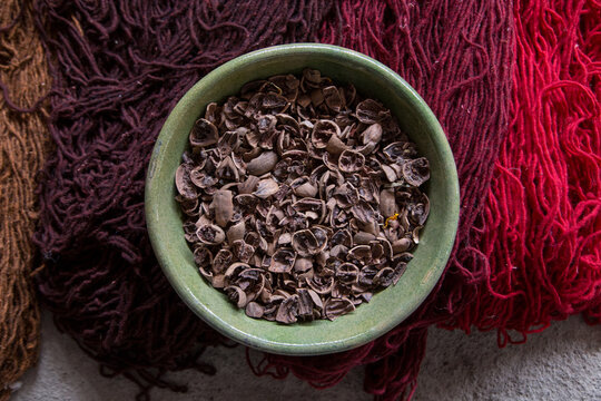 walnut shells on painted threads for Oaxaca rugs