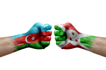 Two hands punch to each others on white background. Country flags painted fists, conflict crisis concept between azerbaijan and burundi