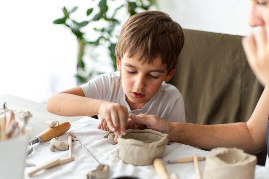 Young Boy Enjoying Working With Clay