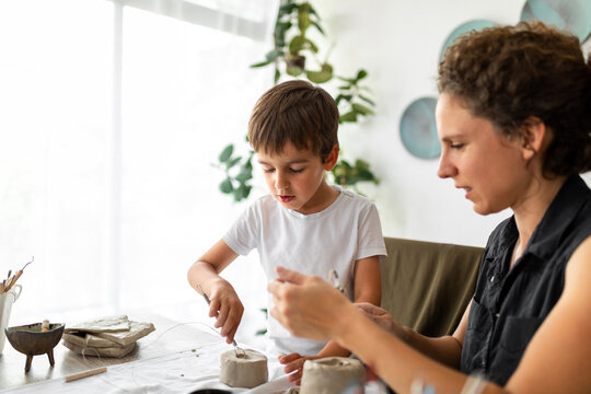 Child Learning Pottery From His Mother