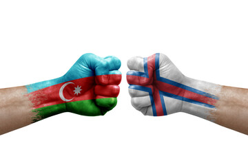 Two hands punch to each others on white background. Country flags painted fists, conflict crisis concept between azerbaijan and faroe islands