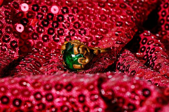 golden ring with a fake green gemstone