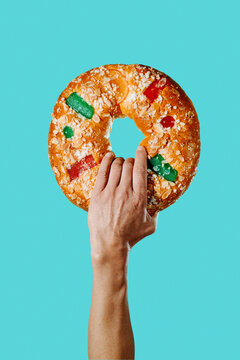 man with a spanish king cake in his hand