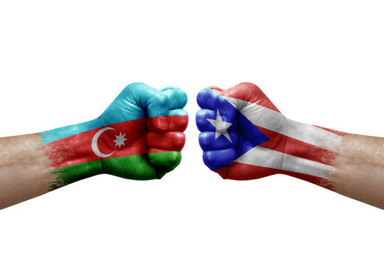 Two hands punch to each others on white background. Country flags painted fists, conflict crisis concept between azerbaijan and puerto rico