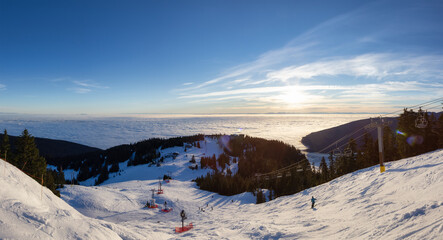 Panoramic View of Top of Grouse Mountain Ski Resort with the City in the background. North Vancouver, British Columbia, Canada. Sunset Sky