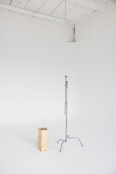 C Stand And Apple Box In Bright White Photo Studio 