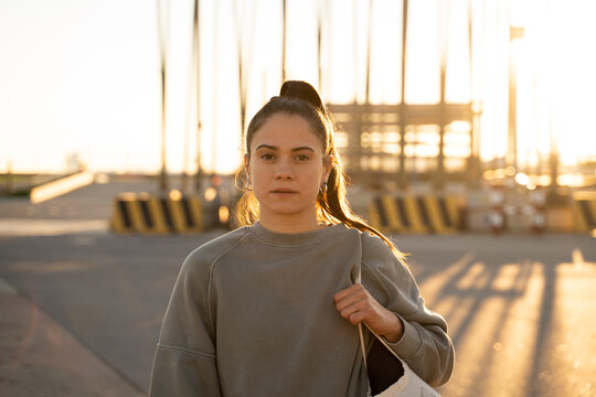 Portrait of confident young woman at sunset