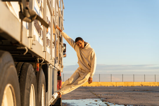 Man hanging from truck 