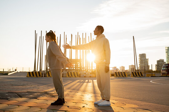 couple standing in urban location at sunset
