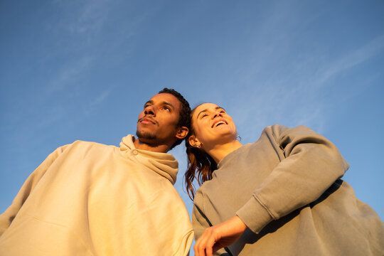 Portrait of friends against blue sky