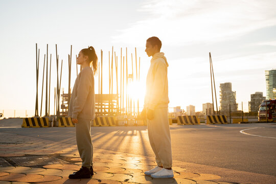 couple standing in urban location at sunset