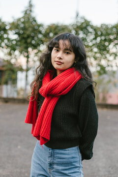 Young southasian woman in red scarf