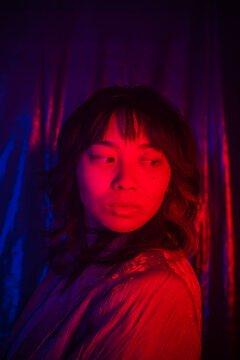 Portrait Of A Cool Asian Woman With Colored Lights.
