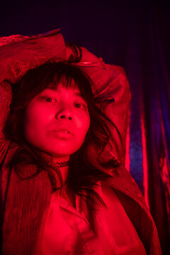 Red Portrait Of A Confident Asian Girl With Gel Lights.