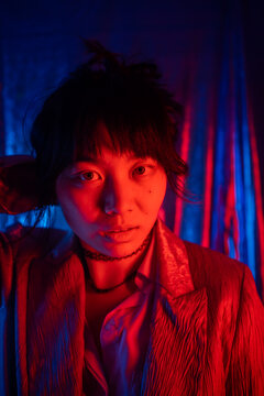 Eye Contact Portrait Of An Asian Girl With Gel Lights.