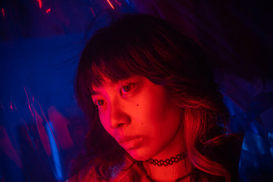 Portrait Of A Cool Asian Woman With Colored Lights.