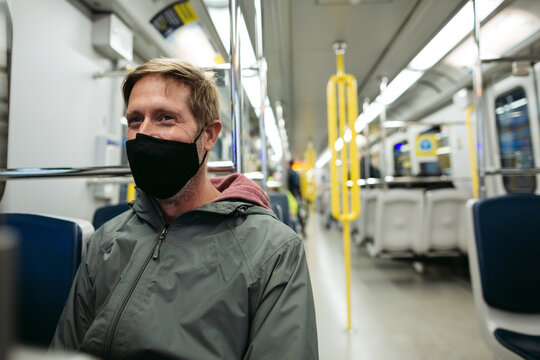 Man on rapid train wearing mask.