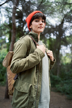 Female traveler standing in forest