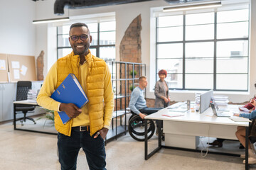 Portrait Of Businessman Holding Folder 