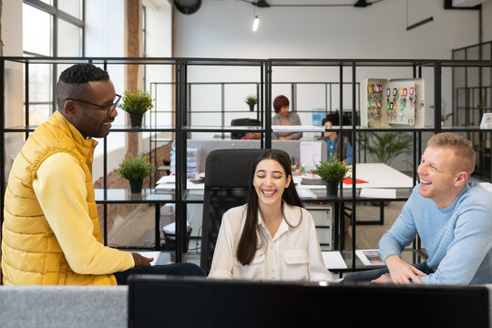Coworkers Laughing Together At Office