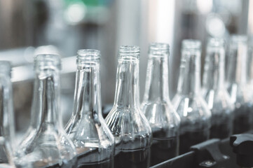 Row of glass bottles to fill with expensive alcohol drinks