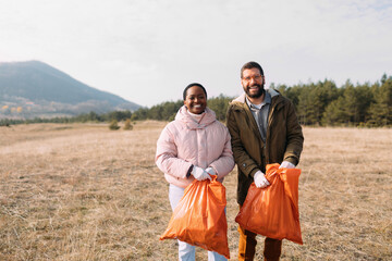 Man and Woman Collecting Garbage in Nature 